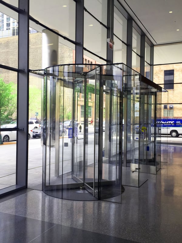 Revolving doors integrated with vestibules