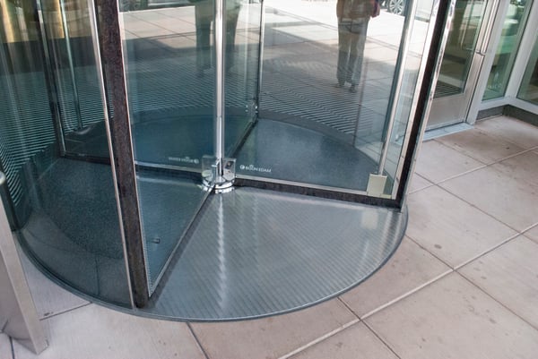 Use a matwell ring or floor frame to install an all-glass revolving door