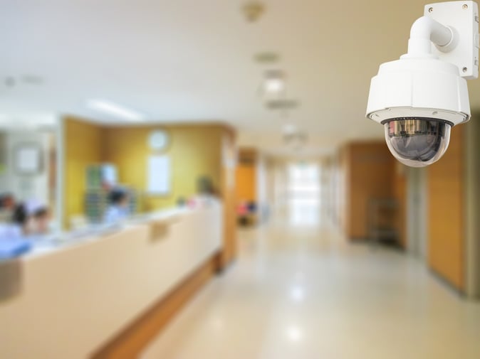 A CCTV camera monitors a secured lobby.